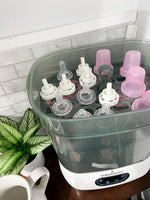 Baby Brezza Sterilizer Dryer open with bottle parts in kitchen - product thumbnail