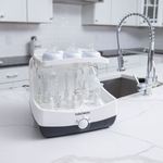 EN Baby Brezza Superfast sterilizer dryer open with bottles and parts in kitchen - product thumbnail