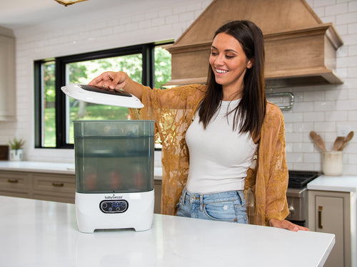 Baby Brezza Sterilizer Dryer used by a woman on kitchen countertop - product thumbnail