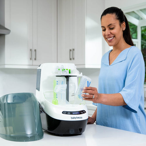 Mother using the Baby Brezza Bottle Washer Pro to clean baby bottles effortlessly - product thumbnail